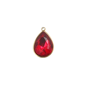 Close-up of red faceted teardrop gemstone pendant with gold-plated stainless steel bezel