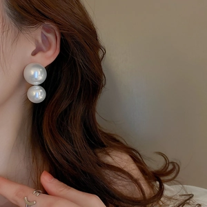 Elegant white double faux pearl stud earrings worn by model for a vintage chic look
