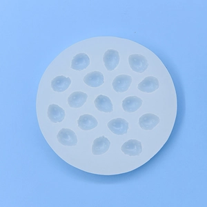 White 17-cavity strawberry silicone mold for baking chocolate and fondant on blue background