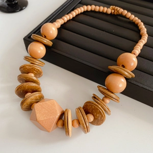 Detailed close-up of beaded wooden necklace with natural geometric facets and texture