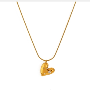 Detailed view of an 18K gold plated heart pendant necklace with shimmering zircon stones