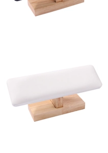 Close-up of professional nail hand rest with white leather cushion and beech wood base