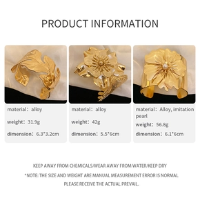 Detail view of gold flower bangles with hollow leaf designs and imitation pearl accents