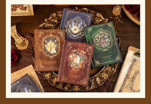 Close-up of vintage A5 hardcover journals with gold foil European patterns on a gold tray