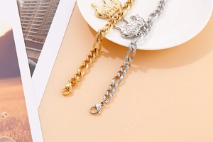 Close-up of gold and silver titanium steel chain bracelets featuring elephant charms