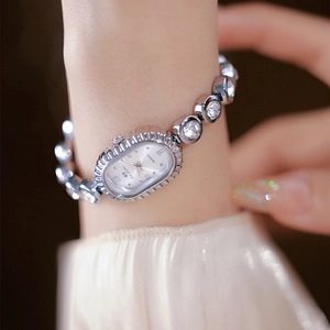 Elegant silver oval wrist watch for women with diamond-studded links and white dial