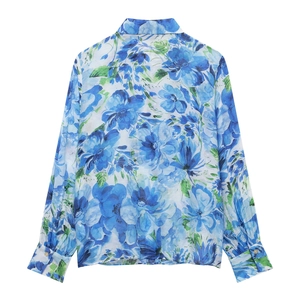 Detail view of back side floral print on blue long sleeve shirt with classic collar