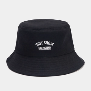 Close-up of high-quality white SHIT SHOW embroidery on a black cotton bucket hat