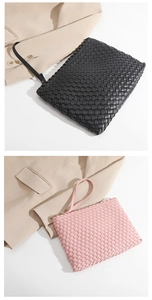 Close-up of woven leather texture on pink and black clutch bags with wristlets