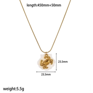 Detail of gold crab pendant on white shell with dimensions and weight measurements