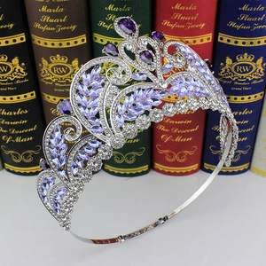 Detailed view of silver bridal crown with purple gemstones set against vintage books