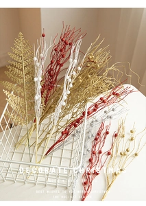 Close-up of glittered Christmas floral branches and berries in a decorative basket