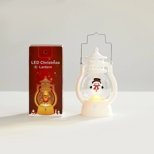 Detail of Christmas LED lantern with snowman inside next to its decorative gift box