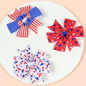 Three-piece American flag hair bow set with stars and stripes on a white plate