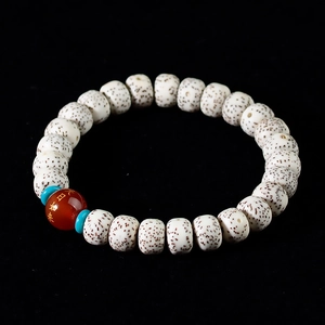 Macro shot of Star Moon Bodhi seeds bracelet with engraved red agate bead and blue spacers