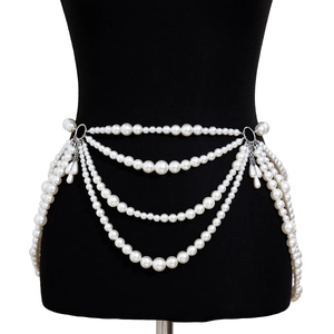 Detail showing elegant multi-layer pearl waist chain with hanging teardrop pendants