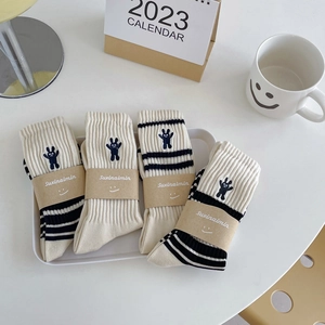 Set of four beige cotton crew socks with black stripes and rabbit embroidery details