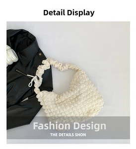 Detail showing the white bubble textured fabric and pleated design of the hobo bag