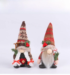 Close-up of knit Christmas gnomes with snowflake hats, candy canes, and ski accessories