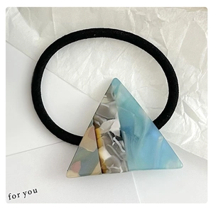 Close-up of a stylish blue and multicolor acetate triangle hair tie on a black elastic band