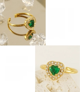 Detail of 18K gold plated heart ring with green gem and white cubic zirconia accents