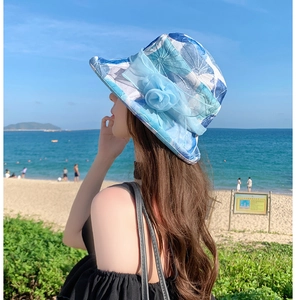 Detail view of floral sun hat with light blue fabric flower and breezy mesh details