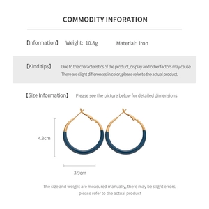 Detail of round two-tone geometric hoop earrings with metal texture and dimensions
