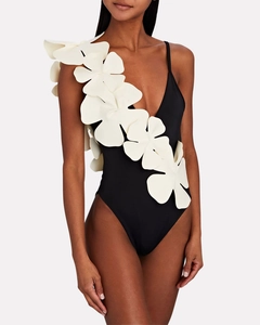 Detail of black V-neck swimsuit featuring a large white 3D floral applique decoration