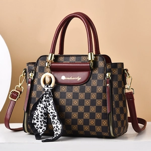 Classic checkered tote bag with dark red handles and a leopard print silk scarf detail