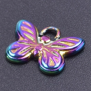 Macro shot of a rainbow butterfly pendant in polished stainless steel for DIY jewelry