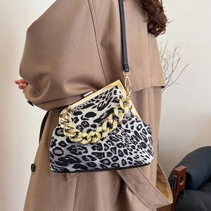Fashion leopard print shell bag with chunky gold chain on trench coat model