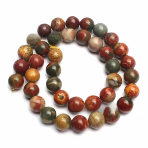 Macro shot of 8mm-10mm natural red Picasso Jasper stone beads with polished texture