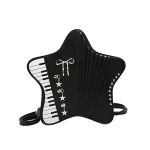 Black star-shaped shoulder bag featuring piano keys, bow detail, and punk metal rivets