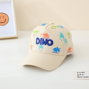 Detail of beige kids baseball cap featuring colorful dinosaur prints and blue DINO embroidery