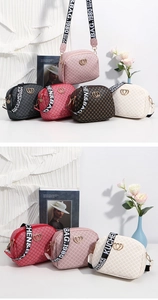 Detailed view of printed shoulder bags featuring heart buckles and lettered straps