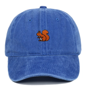 Detail of embroidered orange squirrel on dark blue washed cotton baseball cap