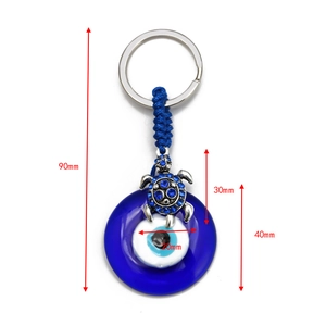 Blue evil eye and silver turtle pendant keychain with dimension markers in 90mm length
