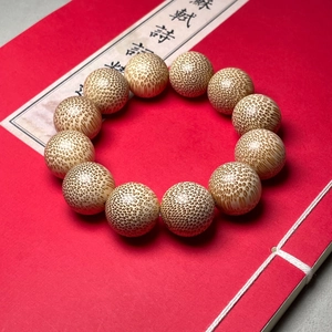 Dragon blood golden silk bamboo bracelet with 12 high-density beads on vintage background