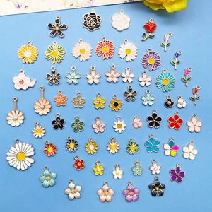 Flat lay of colorful enamel flower charms in various styles for DIY jewelry making