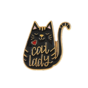 Close-up of a black cat enamel pin with golden Cat Lady text and a small red heart