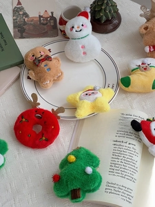 Close-up of assorted Christmas plush charms including gingerbread man and reindeer donuts