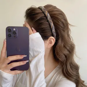 Classic plaid fabric headband with yellow and blue stripes on model with wavy hair