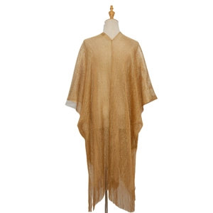 Detail of gold metallic mesh shawl featuring long tassels and V-neck semi-sheer texture
