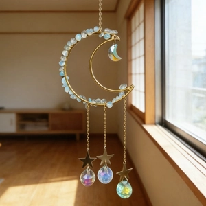 Golden moon crystal suncatcher with light blue stones and iridescent hanging prisms