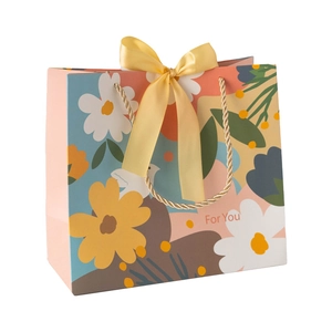 Floral gift bag with yellow ribbon and gold handles, minimalist 'For You' text print