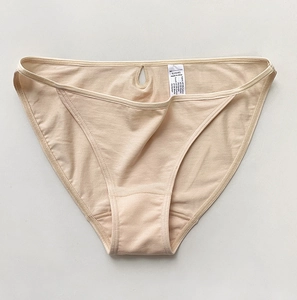 Detail of nude cotton bikini panty showing teardrop cutout and fabric care label