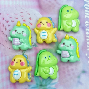 Flat lay of colorful glossy resin dinosaur charms for DIY hair clips and case decor