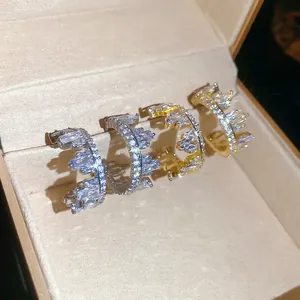 Elegant gold and silver crown rings set with cubic zirconia stones in a jewelry box