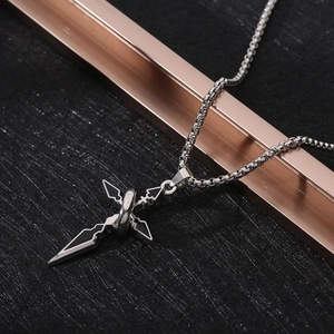 Detail of silver cross pendant with black enamel inlay and sturdy box chain on dark base