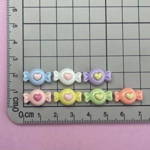 Macro shot of 1.5-2cm heart-shaped candy resin charms in various colors for DIY